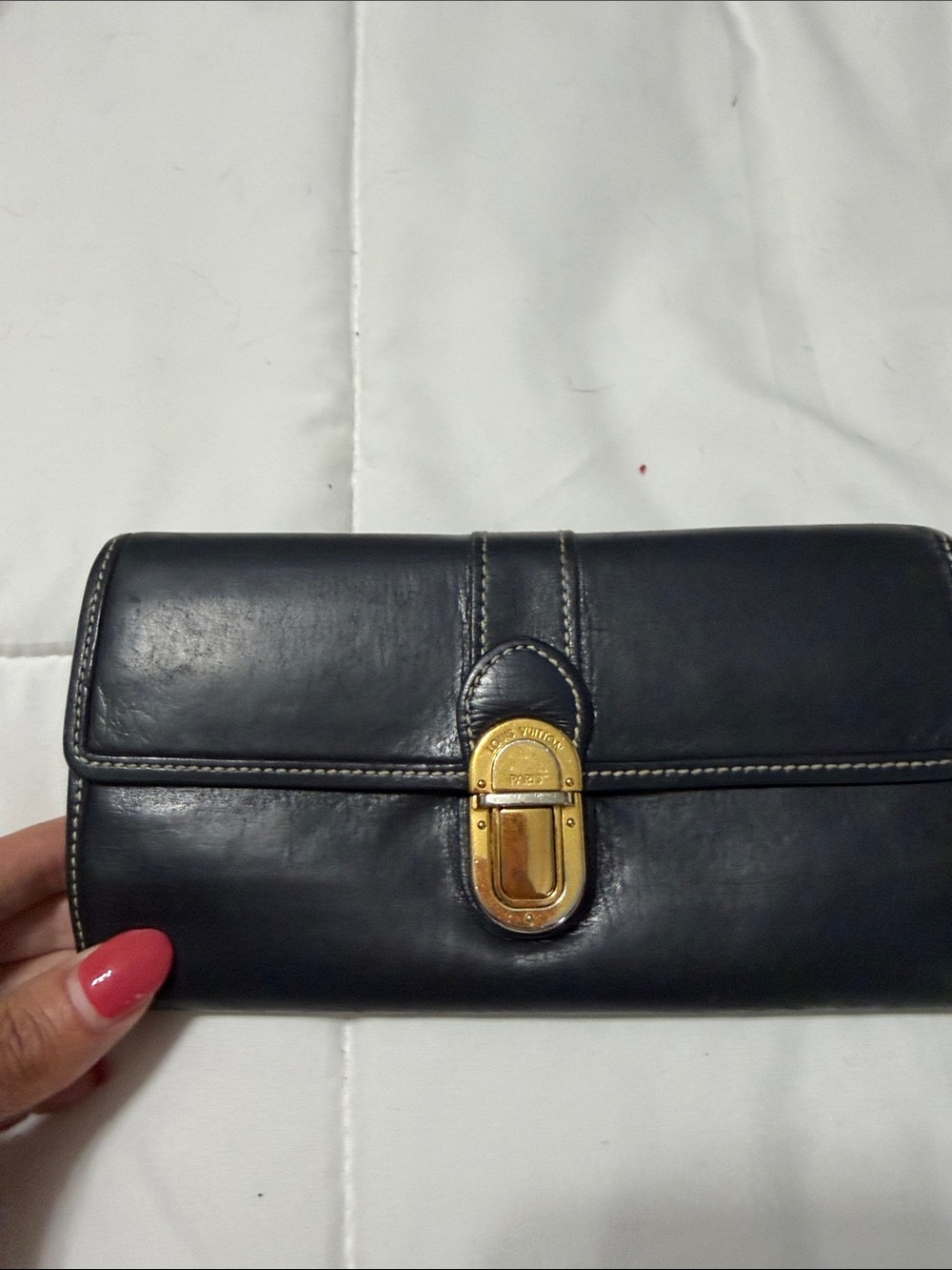 Authentic Louis Vuitton Utah Leather Sarah longwallet with gold toned pushlock.